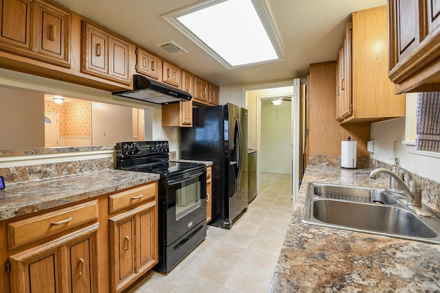 3306 Sycamore Springs Dr, Houston, TX 77339 - kitchen with black appliances, under cabinet range hood, a sink, and brown cabinetry
