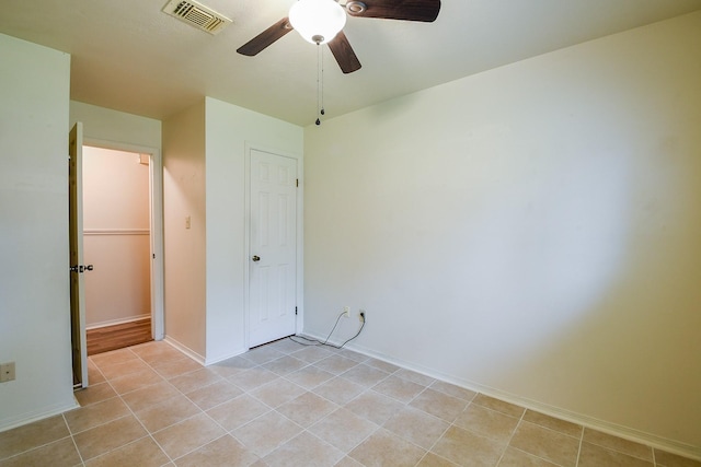 3306 Sycamore Springs Dr, Houston, TX 77339 - unfurnished bedroom featuring light tile patterned flooring, a ceiling fan, and baseboards