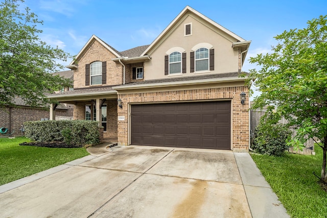 traditional-style home featuring fence, an attached garage, concrete driveway, and a front yard