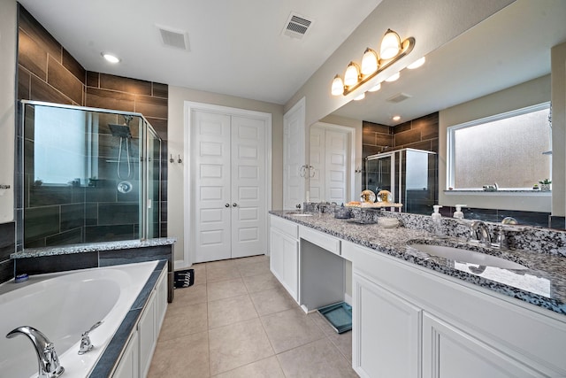 full bathroom featuring a sink, double vanity, a shower stall, visible vents, and a bath