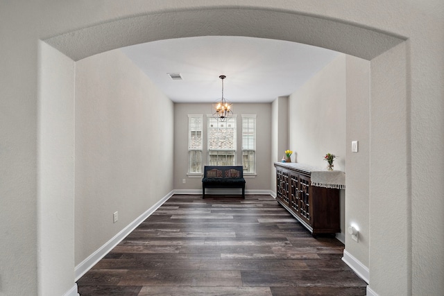 dining room with baseboards, dark wood-style flooring, a chandelier, and visible vents