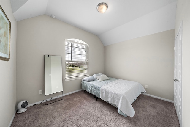bedroom with carpet floors, baseboards, and vaulted ceiling