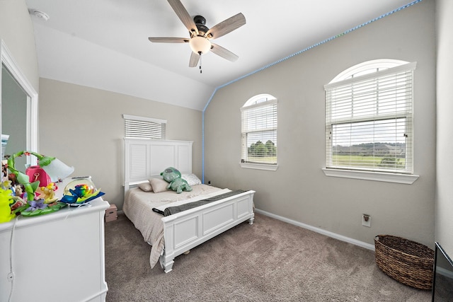 carpeted bedroom with baseboards, vaulted ceiling, and ceiling fan