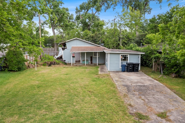 single story home with roof with shingles, stairway, fence, a front lawn, and concrete driveway