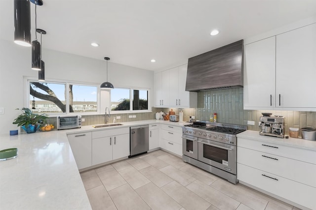 10 Quintana Pl, Galveston, TX 77554 - kitchen with a sink, decorative backsplash, appliances with stainless steel finishes, and premium range hood