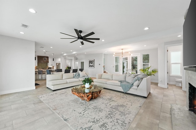 10 Quintana Pl, Galveston, TX 77554 - living room with visible vents, recessed lighting, ceiling fan, and a warm lit fireplace