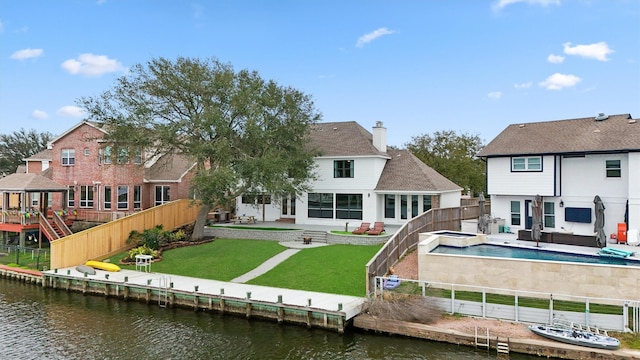 10 Quintana Pl, Galveston, TX 77554 - back of property featuring a water view, a patio area, and a fenced backyard