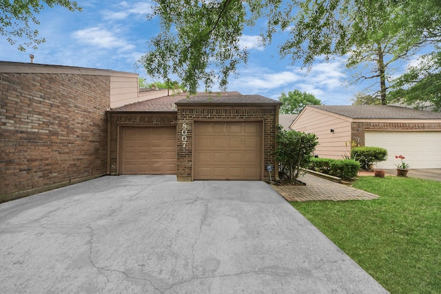 view of front of property with brick siding, a garage, roof with shingles, and driveway