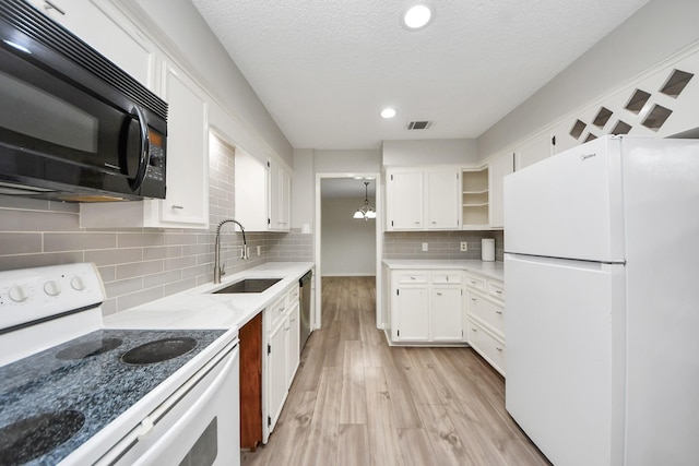 kitchen featuring visible vents, open shelves, white appliances, white cabinets, and a sink