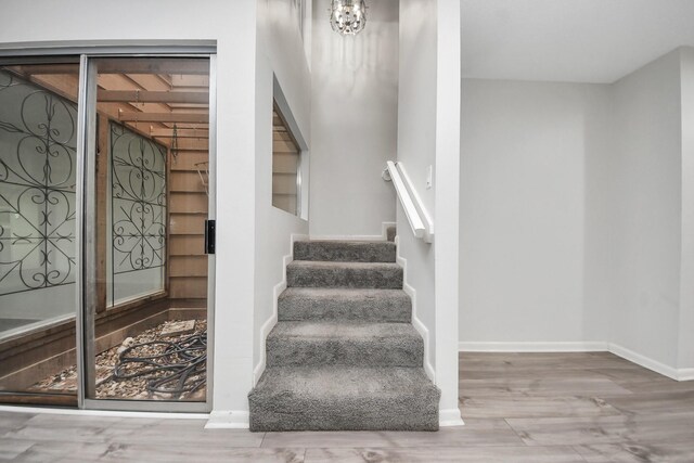 stairs featuring baseboards and wood finished floors