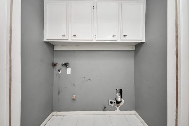 clothes washing area featuring baseboards, washer hookup, electric dryer hookup, and cabinet space
