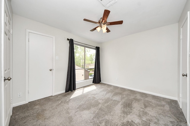 unfurnished bedroom with carpet flooring, baseboards, and visible vents