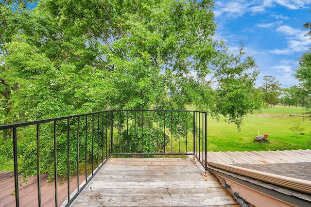 wooden terrace with a lawn