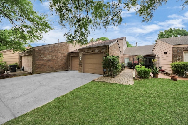 view of front facade featuring concrete driveway, brick siding, an attached garage, and a front yard