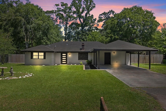 view of front of home with driveway and a carport