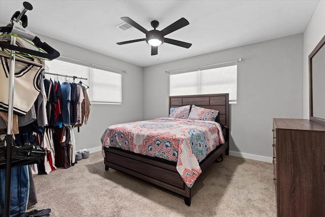 bedroom with carpet flooring, baseboards, and a ceiling fan