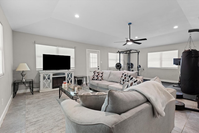 living room featuring healthy amount of natural light, ceiling fan, baseboards, recessed lighting, and lofted ceiling