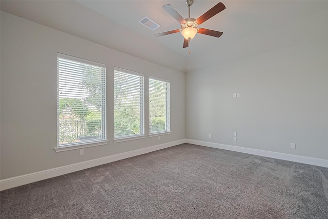 spare room with baseboards, ceiling fan, visible vents, and a wealth of natural light