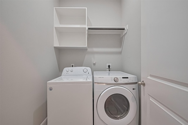 laundry room with laundry area and washing machine and clothes dryer