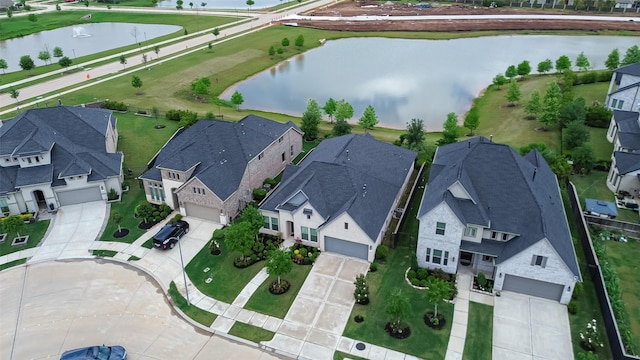 drone / aerial view featuring a residential view and a water view