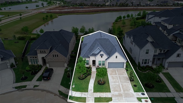 aerial view with a water view and a residential view