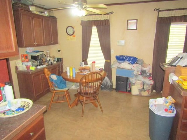 dining room featuring light floors and ceiling fan