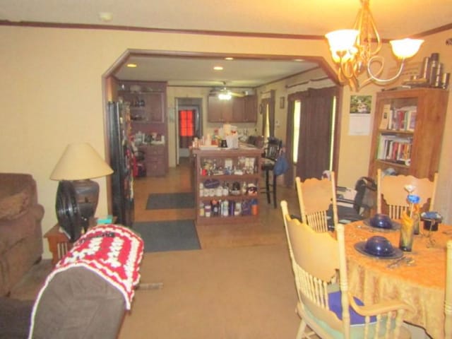 dining room featuring arched walkways and ceiling fan with notable chandelier