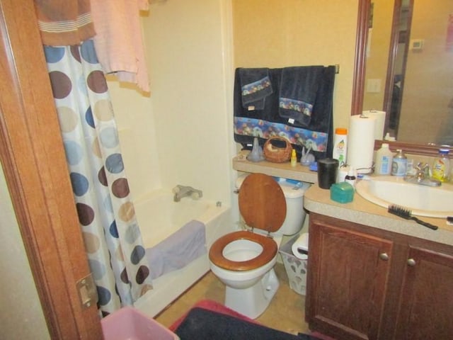 full bathroom with vanity, shower / bath combo, and toilet