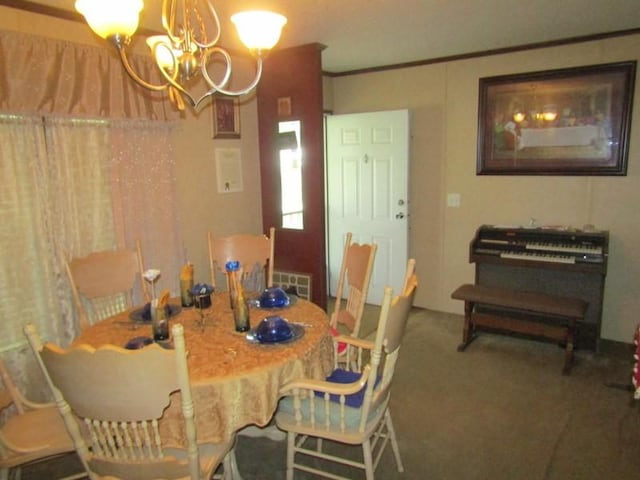 dining space featuring carpet flooring, a notable chandelier, and ornamental molding