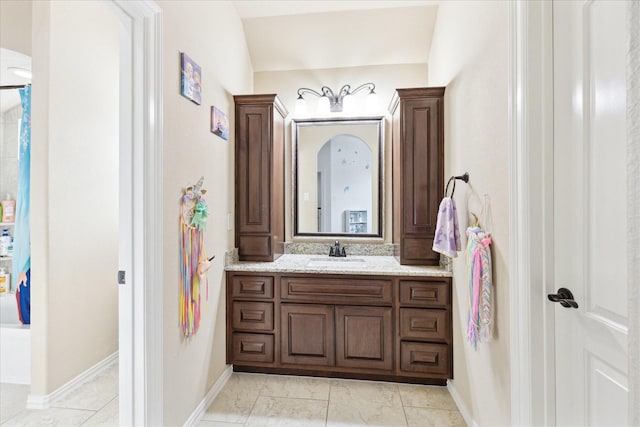bathroom featuring vanity and baseboards