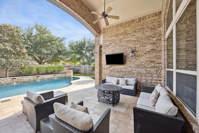 view of patio with a fenced in pool, a ceiling fan, an outdoor living space with a fire pit, and a fenced backyard