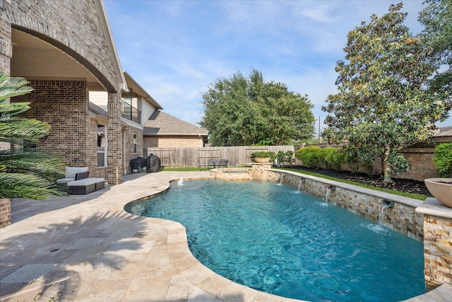view of swimming pool featuring a patio, a fenced in pool, and a fenced backyard