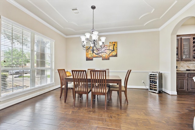 dining room with visible vents, dark wood finished floors, wine cooler, and a healthy amount of sunlight