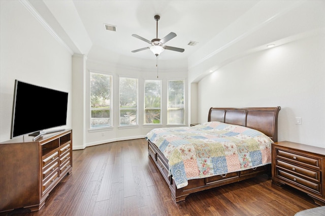 bedroom with visible vents, ornamental molding, dark wood-style flooring, and ceiling fan