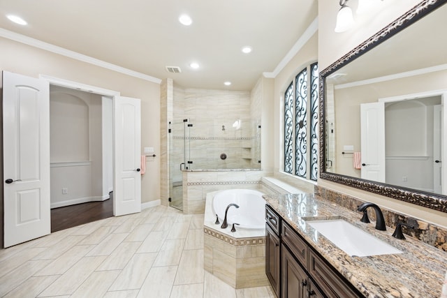 full bathroom featuring a bath, visible vents, crown molding, a stall shower, and vanity