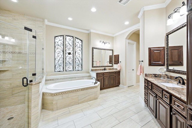 bathroom featuring a sink, visible vents, ornamental molding, a garden tub, and a stall shower