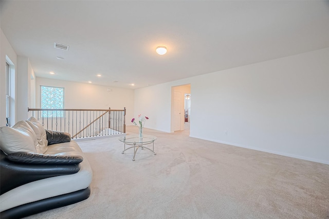 carpeted living area featuring visible vents and recessed lighting