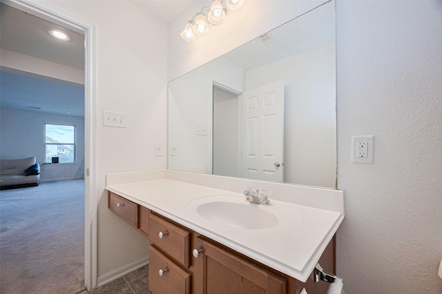 bathroom featuring baseboards and vanity