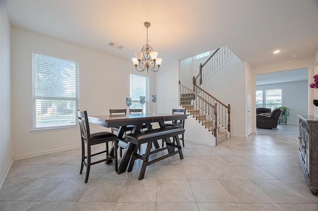 dining area featuring an inviting chandelier, plenty of natural light, light tile patterned floors, and visible vents