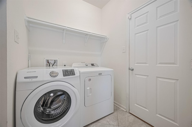 clothes washing area featuring light tile patterned floors, laundry area, and independent washer and dryer