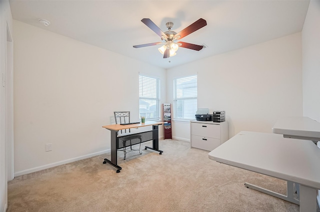 office with ceiling fan, light colored carpet, and baseboards