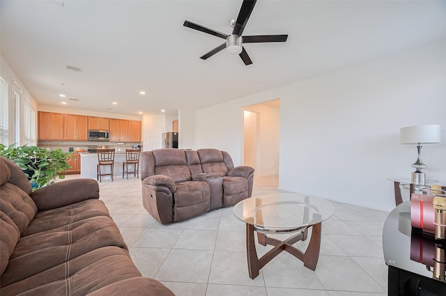 living area featuring recessed lighting, ceiling fan, and light tile patterned floors