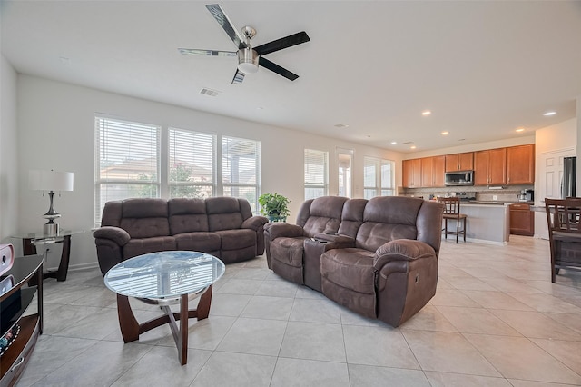 living area with a ceiling fan, recessed lighting, light tile patterned flooring, and visible vents