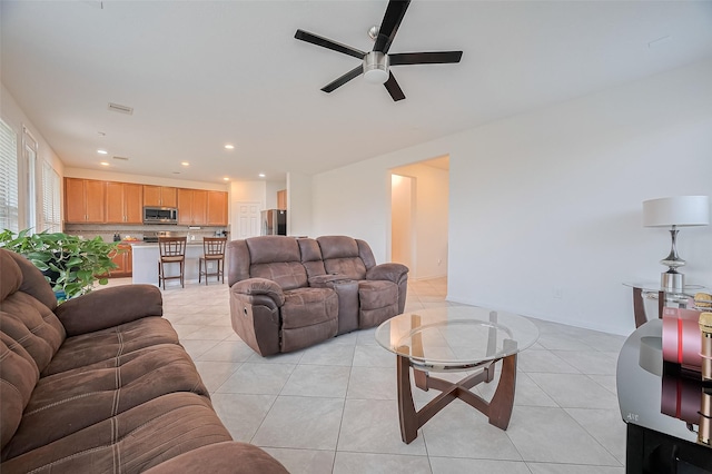 living area with ceiling fan, recessed lighting, and light tile patterned flooring