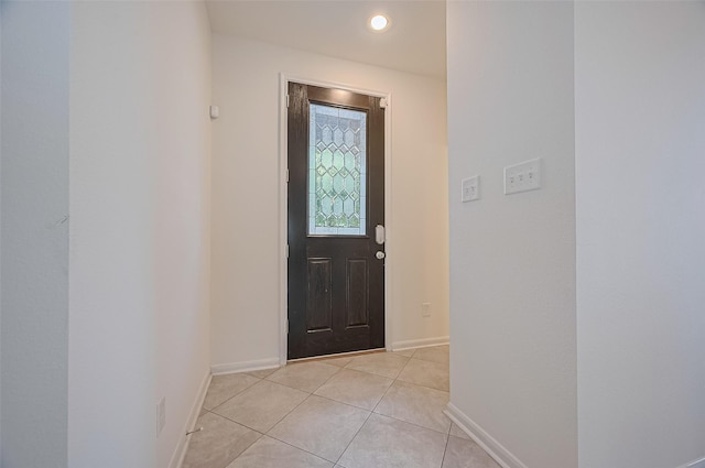 foyer with baseboards and light tile patterned flooring