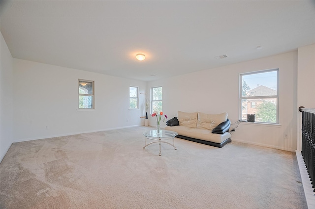 carpeted living room featuring visible vents and baseboards