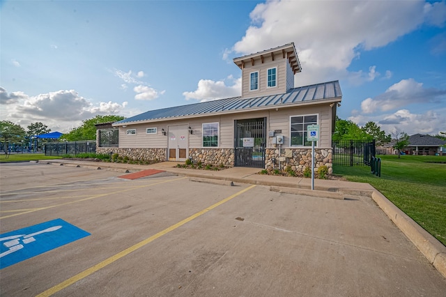 exterior space featuring fence and uncovered parking
