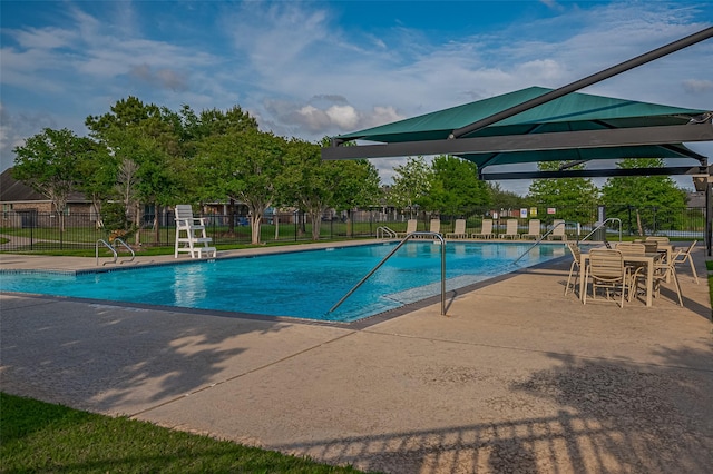 pool featuring a patio area and fence
