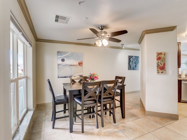 dining area with crown molding, ceiling fan, visible vents, and light tile patterned floors