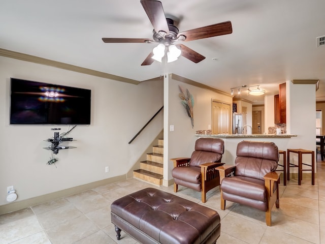living room with crown molding, stairs, a ceiling fan, and light tile patterned floors
